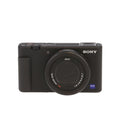 Black Sony camera with Zeiss lens on a white background