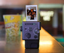 Fujifilm Instax Mini Evo Cinema printing a photo with a QR code for smartphone video playback