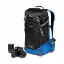Lowepro PhotoSport BP 15L AW III outdoor camera bag displayed next to a Fujifilm mirrorless camera and an extra prime lens.