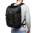 Rear angle view of a photographer wearing the rugged Lowepro ProTactic BP 300 AW II backpack showcasing the structured ActivZone ergonomic back panel.