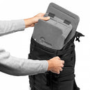 Hands removing the modular QuickShelf internal structure from the top compartment of the Lowepro ProTactic BP 300 AW II backpack to convert it into a laptop bag.