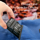 A hand sliding the ultra compact KingMa Sony battery charger directly into a blue canvas backpack travel pocket.