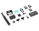 Overhead angled layout of the full DJI Osmo Action 4 Adventure Combo showing the camera, extension rod, three batteries, and mounts.