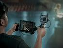 Operator holding a handheld monitor rig equipped with the DJI SDR Transmission 2 transceiver provided by best camera stores.