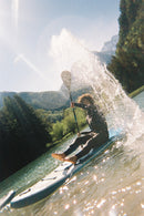 Sample photo taken with FUJIFILM QuickSnap Active showing water splashing while paddleboarding, available at Best Camera Store.