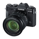 Front oblique view of the black Fujifilm X-T30 mirrorless camera body with the Fujinon XF 16-80mm f-4 R OIS WR lens mounted showing the 72mm front glass element