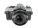 Front view of a used mint Minolta X-70 camera with 50mm lens and no scratches.