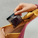 Person taking the Insta360 X6 Xtreme Battery out of a protective pouch inside a bag, from best Camera Store.