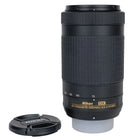 Nikon AF-P Nikkor 70-300mm lens with lens cap on a light gray background