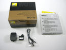 Close-up of Nikon WU-1b Wireless Mobile Adapter retail box, storage case, manual, and lanyard strap showing all included open-box items.