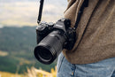 A photographer using the lightweight Nikon Z 24-105mm f4-7.1 lens for travel photography.