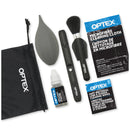 Overhead flat lay of the Optex 7-in-1 cleaning kit items including the black travel pouch, anti-roll air blower, precision lens pen, brush, liquid fluid, and microfiber cloths.