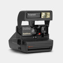 Front angle view of the dark grey used Polaroid 600 OneStep AutoFocus instant camera at Best Camera Store