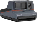 Front view of a dark grey Polaroid Impulse 600 instant camera in excellent used condition.