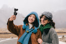Two people taking a selfie  with Insta360 luna pocket  camera in a snowy landscape