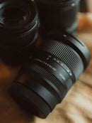 Photographer holding Sony camera equipped with Sigma 20-60mm F2.8-4 DG Contemporary lens at Best Camera Store