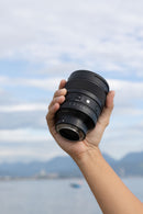 Sigma 85mm f1.2 DG Art lens held in hand outdoor shot - Best Camera Store