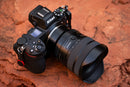 Clean studio profile shot of the black Tamron 12-20mm F2.8 ultra-wide zoom lens showing focal markings and control switches, available at Best Camera Store.