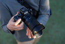 A user holding a Nikon Z camera body paired with the Tamron 17-70mm f2.8 zoom lens outdoors.