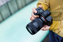 The compact Tamron 35-100mm f/2.8 zoom lens attached to a Sony Alpha mirrorless camera body.