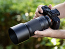 Tamron 70-300mm f/4.5-6.3 lens mounted on a Sony full-frame camera held in hand, available at Best Camera Store.