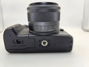 Side profile view of the used Canon M50 Mark II showing the clean, exposed digital output ports where the rubber port door is missing.