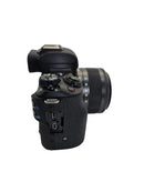 Side profile view of the used Canon M50 Mark II showing the clean, exposed digital output ports where the rubber port door is missing.