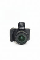 Front view of a pre-owned black Canon EOS M50 mirrorless digital camera body mounted with the compact EF-M 15-45mm f-3.5-6.3 IS STM kit zoom lens.