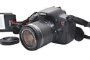 Front view of a used, good condition Canon EOS Rebel T5i DSLR with EF-S 18-55mm IS lens attached.
