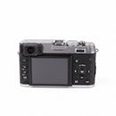 Rear LCD screen, hybrid viewfinder, and controls of used Fujifilm X100 camera from Best Camera Store.