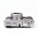 Top plate of used silver vintage Fujifilm X100 showing control dials, available at Best Camera Store.