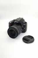 Front view of a used, mint condition Nikon D3300 DSLR camera body with the 18-55mm AF-P DX lens and front cap attached at Best Camera Store.
