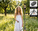 Woman using VIP Q575TK AI Face Tracking Tripod in wildflower meadow available at Best Camera Store